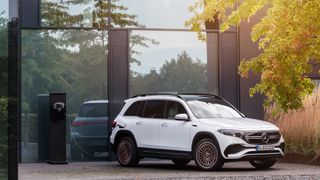 Mercedes-Benz EV plugged into a charger outside a house