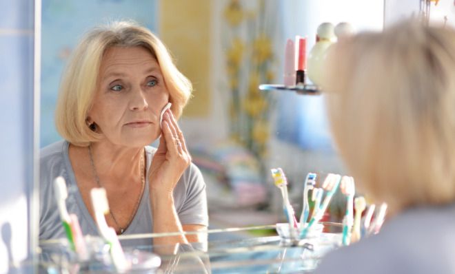 Older woman washing face