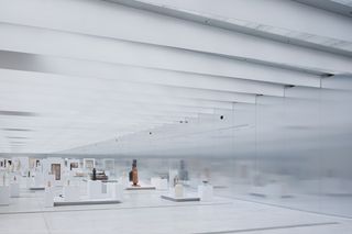A 120-m-long room with polished aluminium walls and blade-like metal ceiling beams.