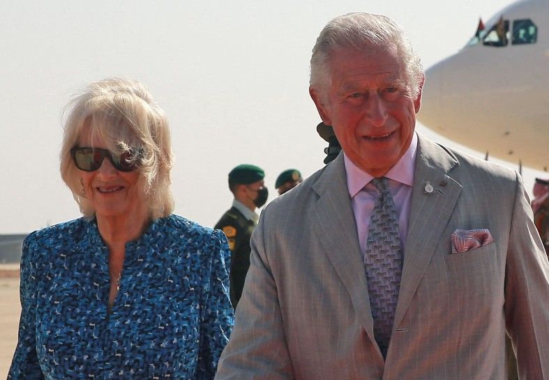 Britain&#039;s Prince Charles, the Prince of Wales, and his wife Camilla, Duchess of Cornwall, are received upon their arrival at Queen Alia International Airport