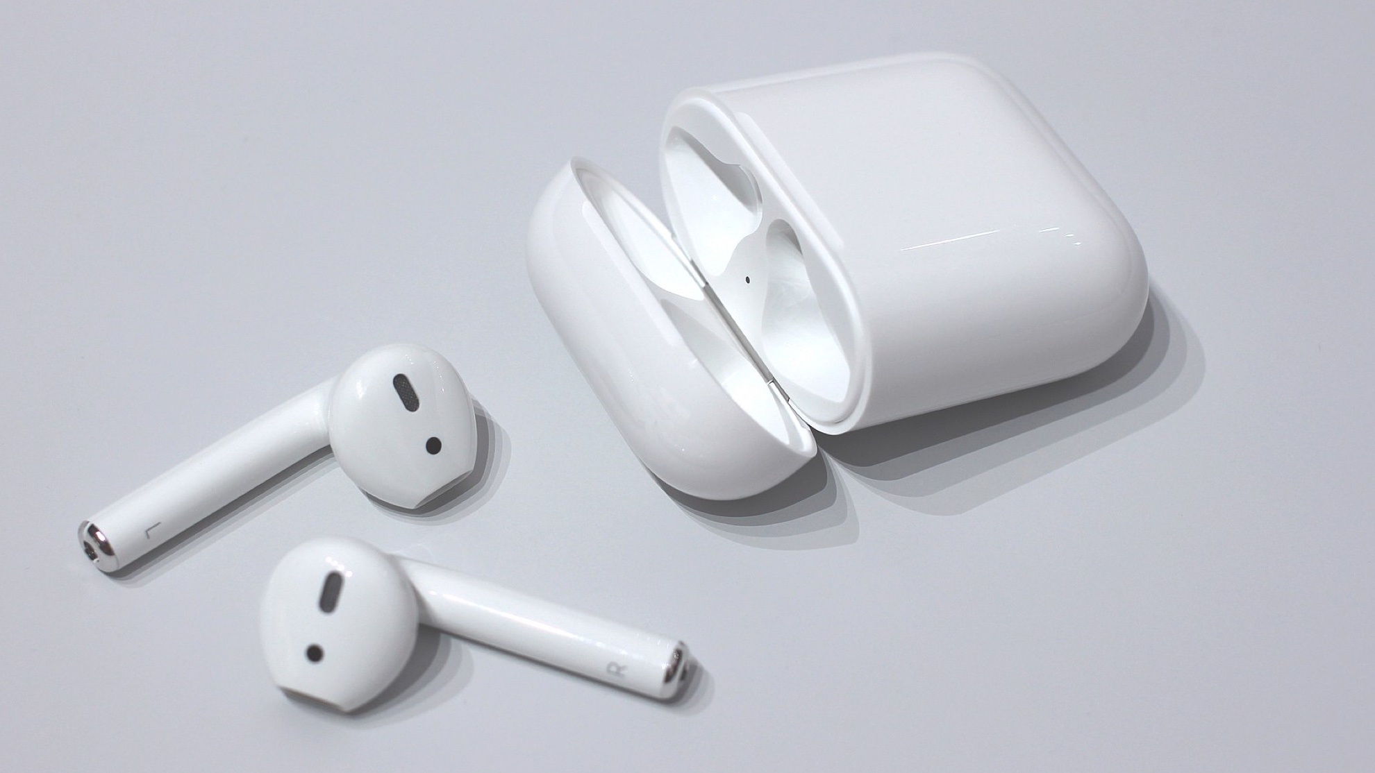 A pair of AirPods with a charging case