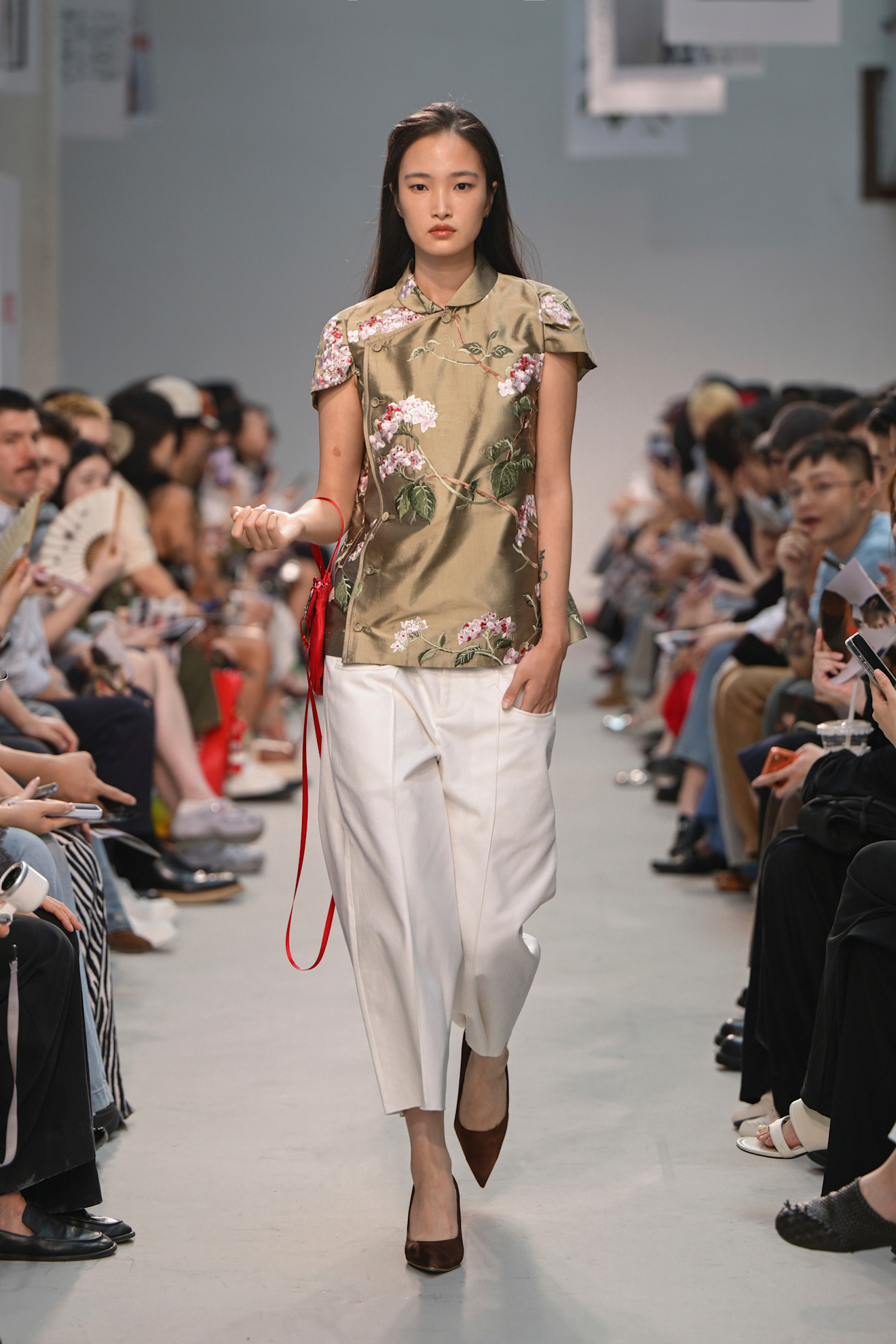 Ao Yes PO Spring/Summer 26 runway model wears top and white trousers
