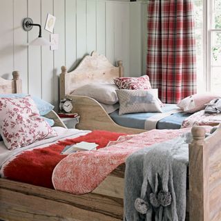 bedroom with wooden bed and checkered curtains