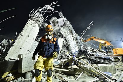 A rescuer works at the site of a Taiwan earthquake