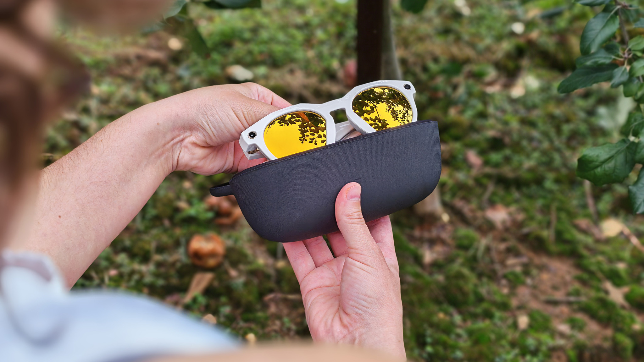 Pulling Oakley Meta HSTN smart glasses out of their charging case
