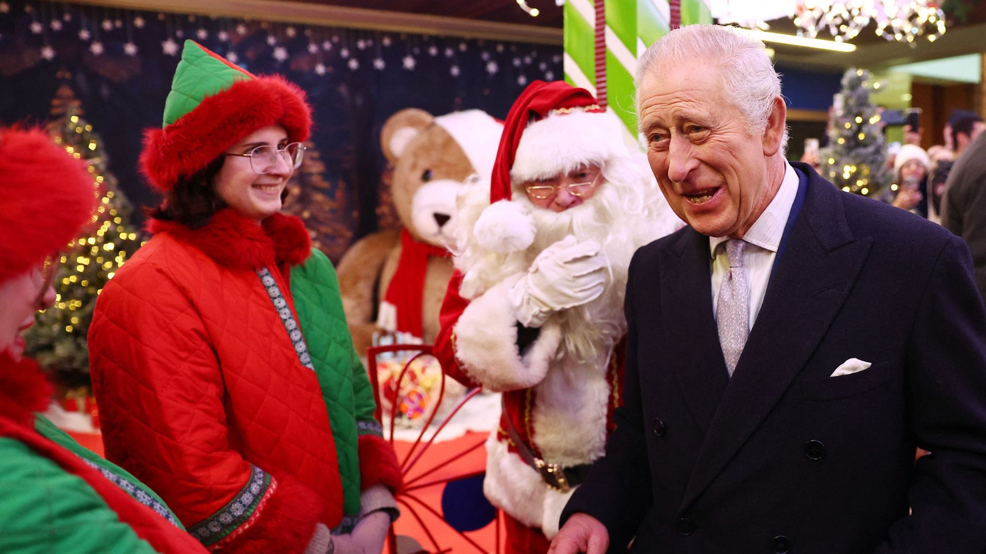 King Charles meets a Father Christmas during his visit to the Christmas Market at Ealing Broadway Shopping Centre in west London