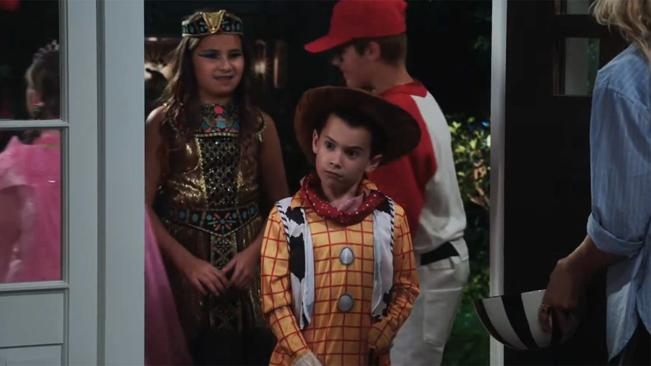 Kid in a Woody costume standing in Matt&#039;s doorway in the Halloween episode of Shifting Gears.
