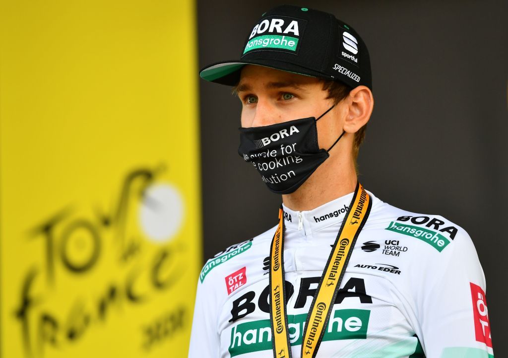 Team UAE Emirates rider Slovenias Tadej Pogacar celebrates his white jersey of best young on the podium at the end of the 16th stage of the 107th edition of the Tour de France cycling race 164 km between La Tour du Pin and VillarddeLans on September 15 2020 Photo by Stuart Franklin various sources AFP Photo by STUART FRANKLINAFP via Getty Images