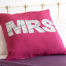 bed with pink coloured cushion