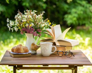 book and bouquet of flowers outdoors