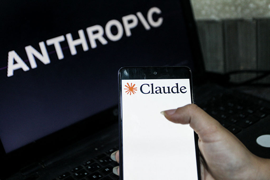 Illustration photo showing the Claude logo displayed on a smartphone and the Anthropic logo on a computer screen (Photo by Imen Ben Youssef / Hans Lucas via AFP)