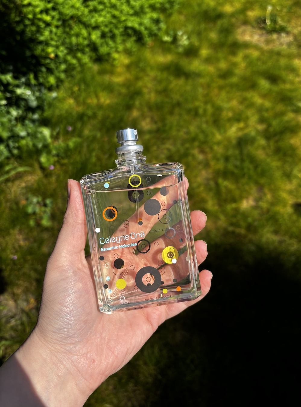 Mica Ricketts holding bottle of Escentric Molecules Cologne One