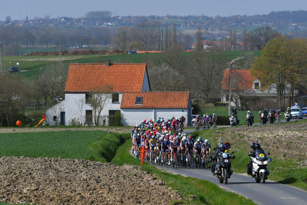 WAREGEM BELGIUM MARCH 31 The Peloton during the 75th Dwars Door Vlaanderen 2021 Mens Elite a 1841km race from Roeselare to Waregem Landscape DDV DDV21 FlandersClassic A travers la Flandre on March 31 2021 in Waregem Belgium Photo by Luc ClaessenGetty Images