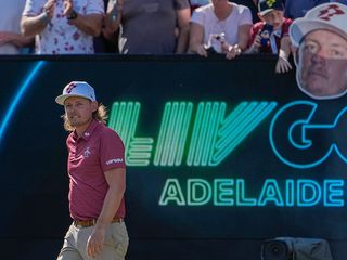 Cam Smith in front of a LIV Golf Adelaide sign
