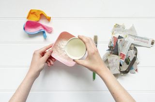 Pour the water into the flour to make a paper mache paste