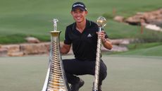 Collin Morikawa with the Race To Dubai and the DP World Tour Championship trophies after he won the 2021 DP World Tour Championship in Dubai
