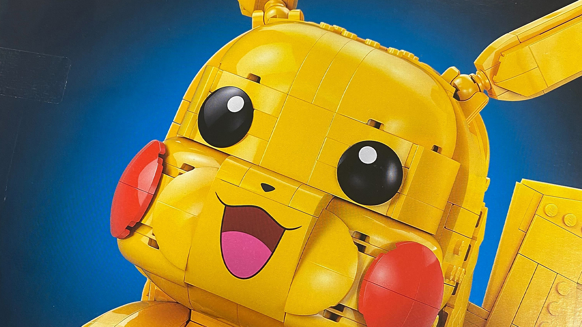 Lego Pikachu against a black and blue background