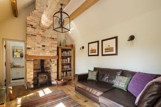 a vaulted space with a large brick fireplace