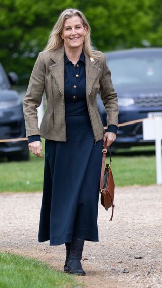Duchess Sophie nails navy in suede ankle boots and flowing spring midi ...