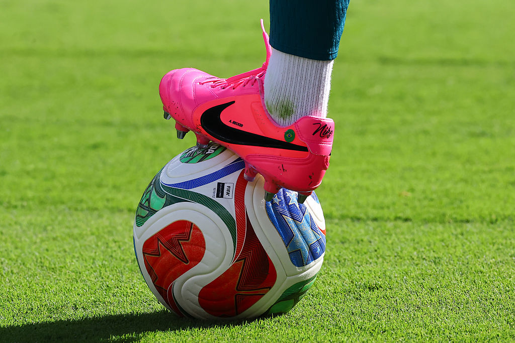 View of the Nike cleat and Adidas Match Ball under the foot of Alisson Becker #1 of Brazil
