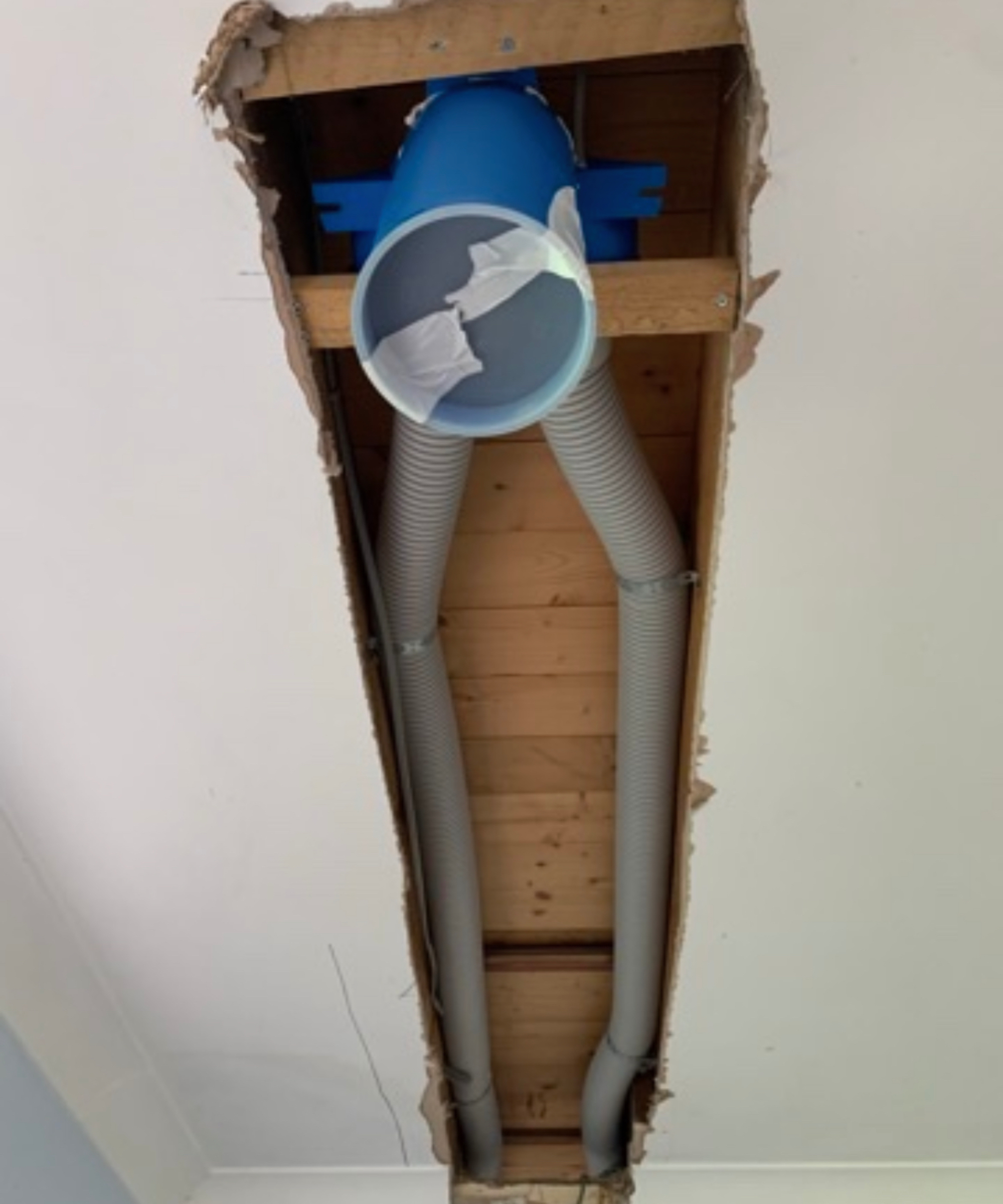 ceiling cut open showing MVHR ducting inside and vent