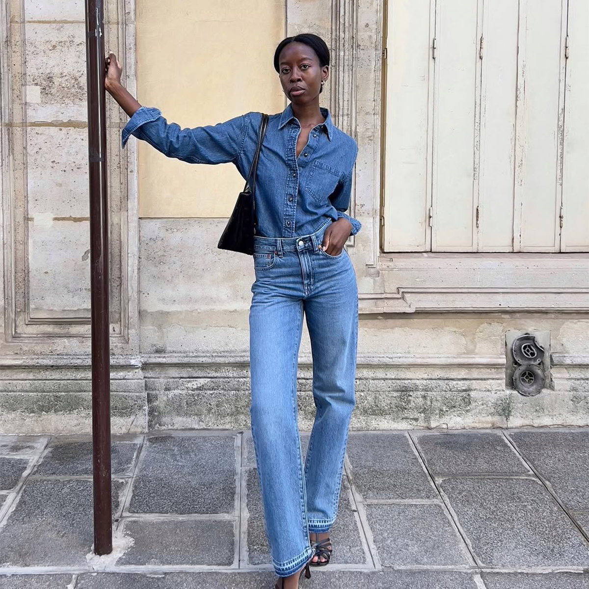 Influencer Sylvie Mus wears Madewell jeans and a denim button-up. 