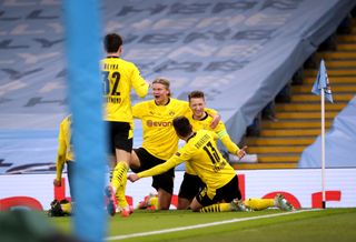 Marco Reus, right, and Erling Haaland, centre, celebrate with team-mates after Dortmund's equaliser