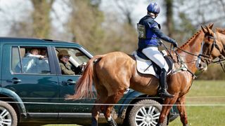 Princess Anne rides her jeep alongside Zara Tindall on horseback