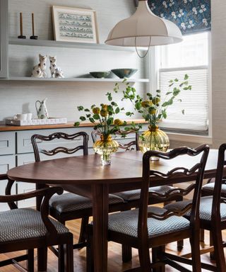 A dining room with antique dining chairs with a wavy back detail