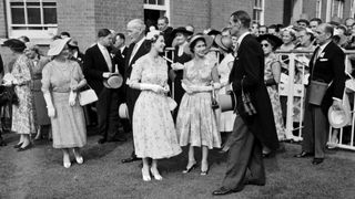 Queen Elizabeth II and Princess Margaret greet trainer Noel Murless in the unsaddling enclosure at Ascot, after the Queen's horse Jardiniere