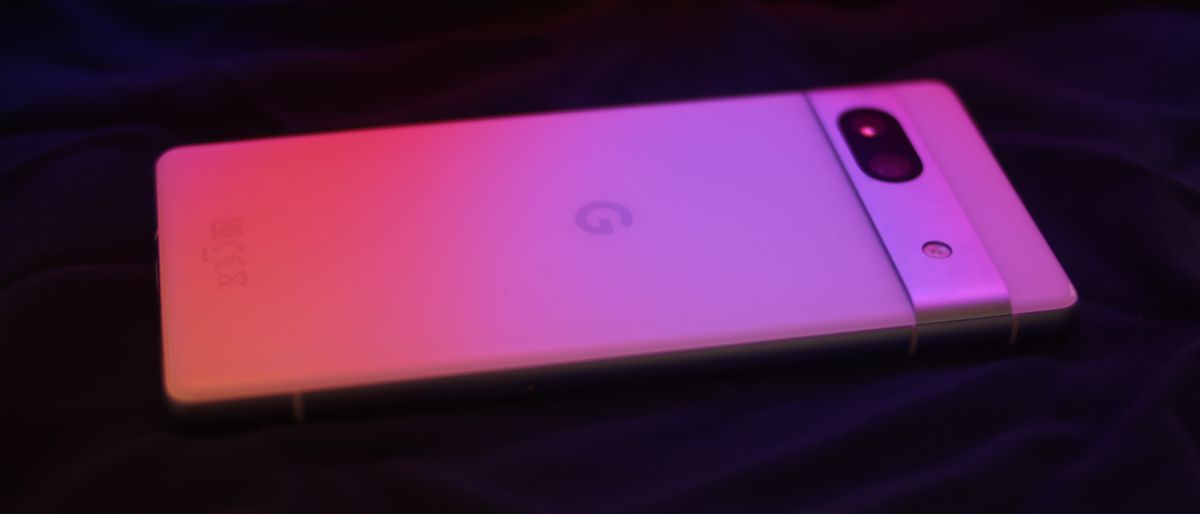 Google Pixel 7a phone under a red and pink light