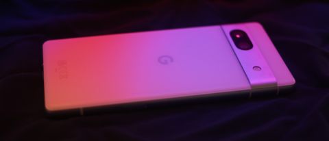 Google Pixel 7a phone under a red and pink light