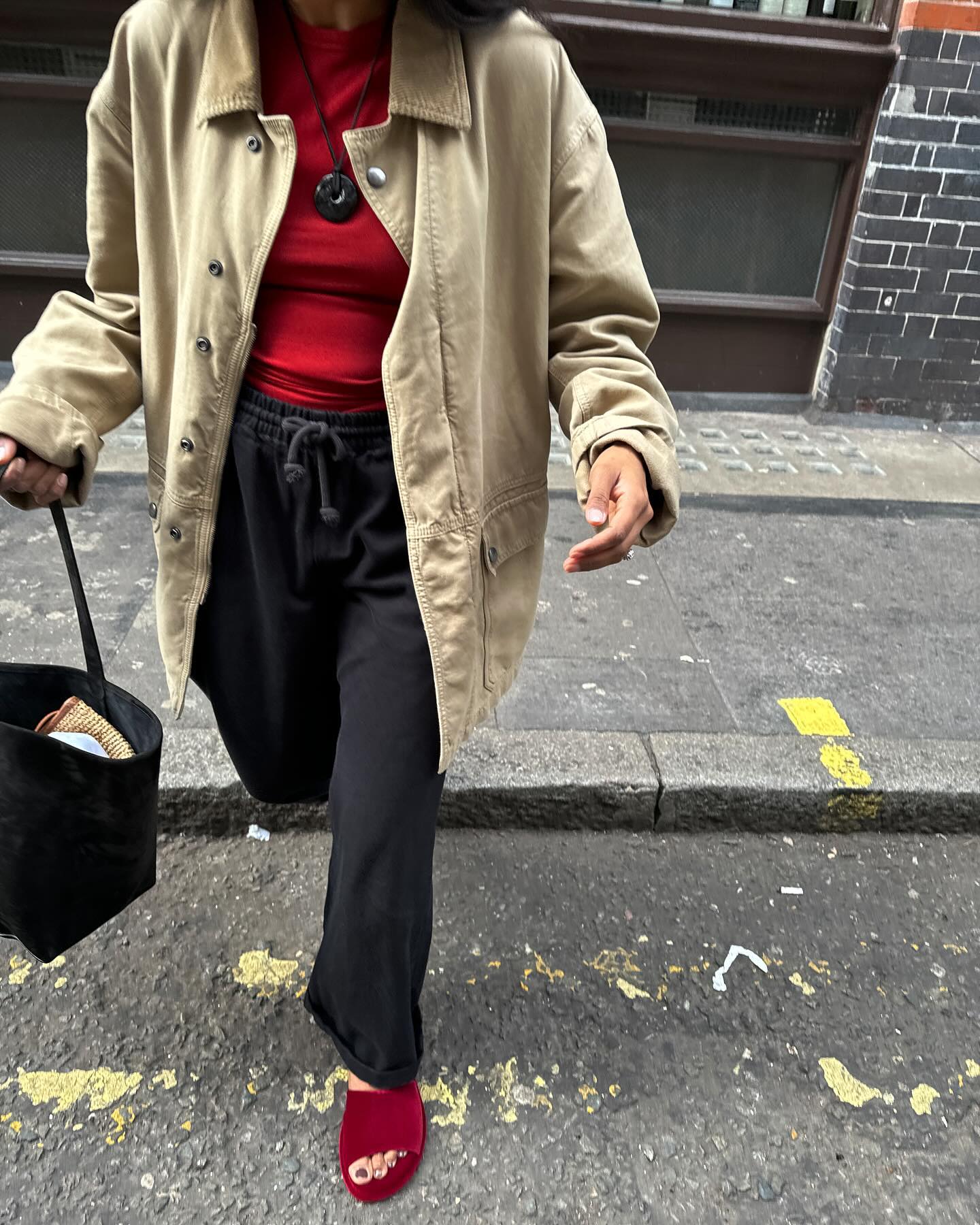 Monikh wearing red top and black trousers with red sandals and toffee pedicure
