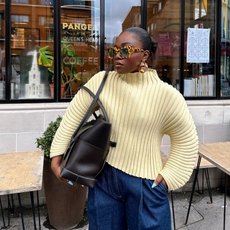 @fisayolonge wears yellow top, sunglasses, blue jeans