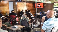 Men in Lebanon watch Hezbollah leader Hassan Nasrallah on TV