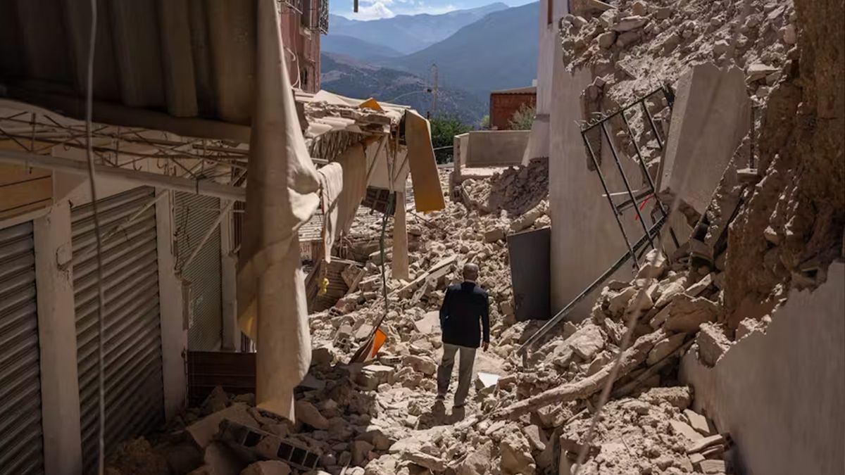 A man stands in the middle of collapsed buildings after the earthquake in Moulay Brahim, Morocco.