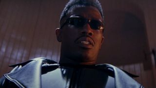 Wesley Snipes stands concerned in a vampire hideout in Blade.