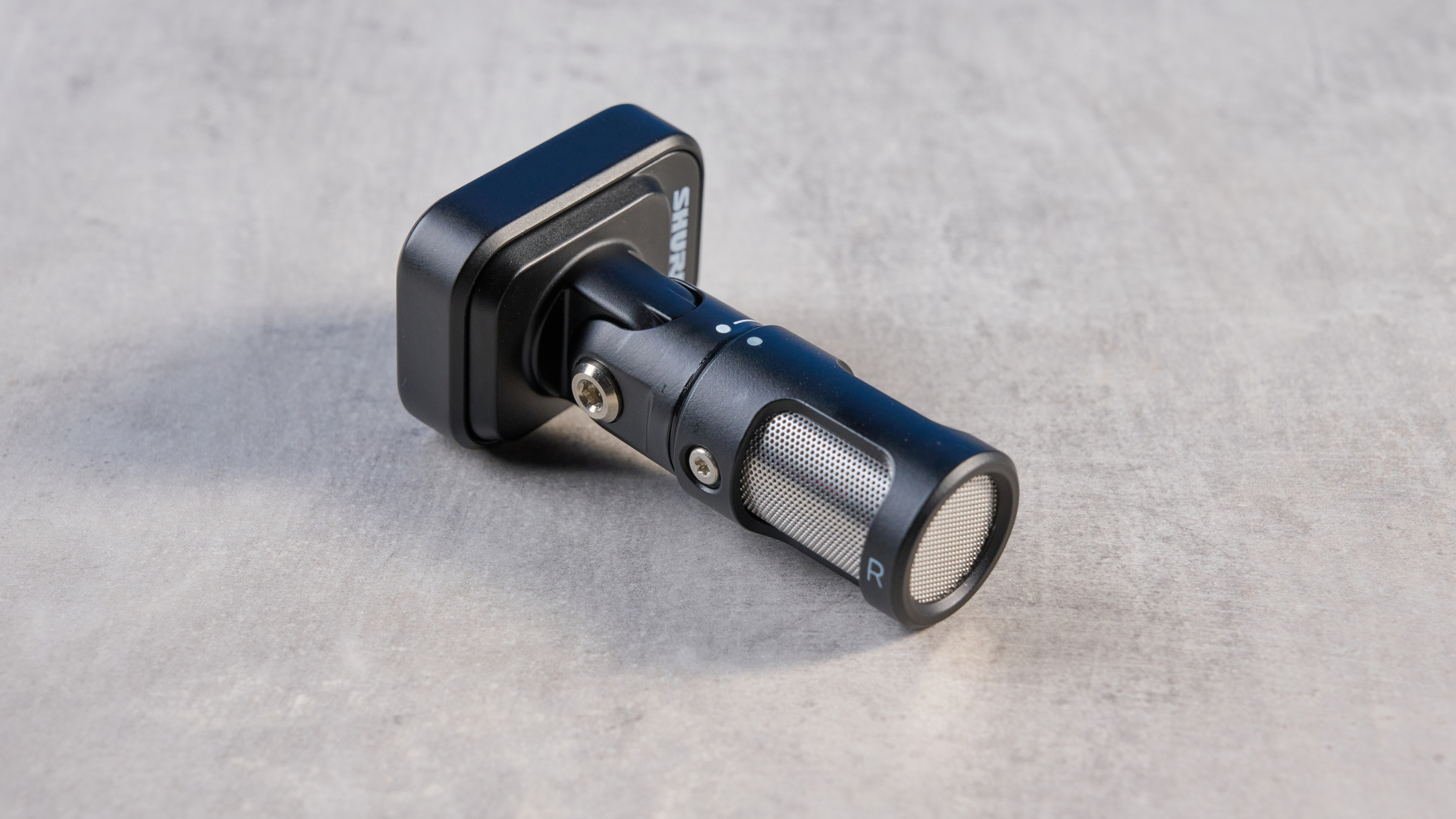 the shure mv88 usb-c microphone photographed against a blue tom's guide background and shown connected to a google pixel 10 pro