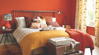 autumnal bedding in a rust orange room