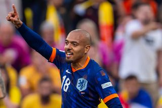 Donyell Malen celebrates after scoring for the Netherlands against Romania at Euro 2024.
