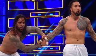 Jey and Jimmy Uso getting ready to jump over the top rope WWE