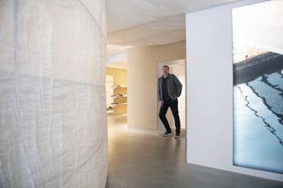 Kjetil Traedal Thorsen photographed in the curved paper passage of the Holzweiler flagship store on Prinsens Gate, Oslo
