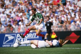 Mexico's Luis Garcia jumps over USA's Alexi Lalas in a match in June 1995.