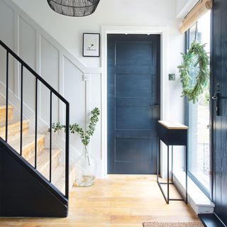 black and white hallway with staircase