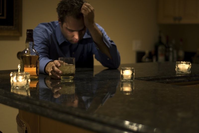 a guy at a bar drinking beer