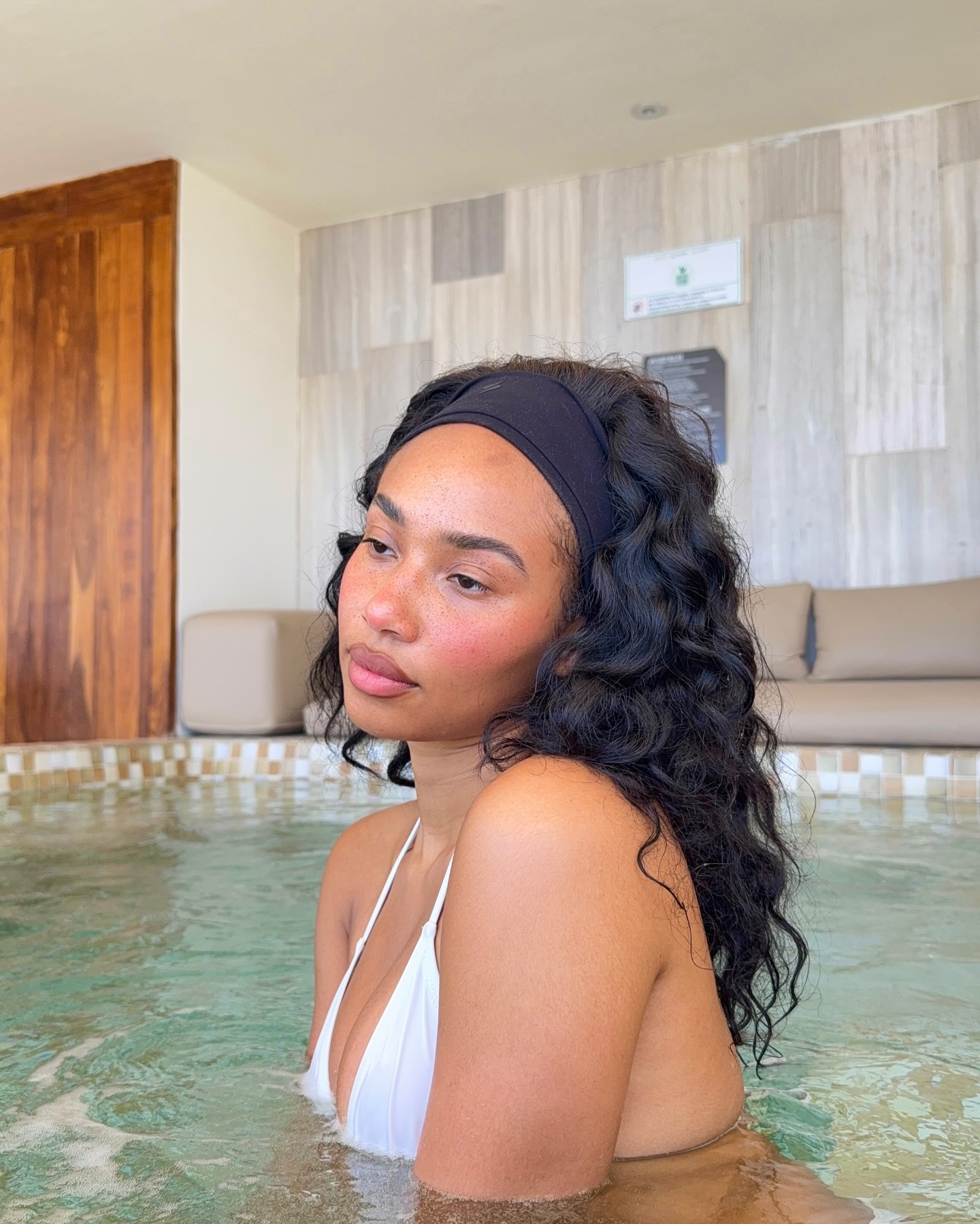 Photo of a woman wearing a wide headband in the pool