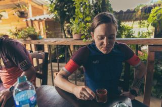 Anne-Marije Rook sporting a Safetti gravel jersey while enjoying a Colombian coffee