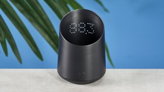 a black plastic coffee doser with an aesthetically pleasing design and a curved built-in LED screen