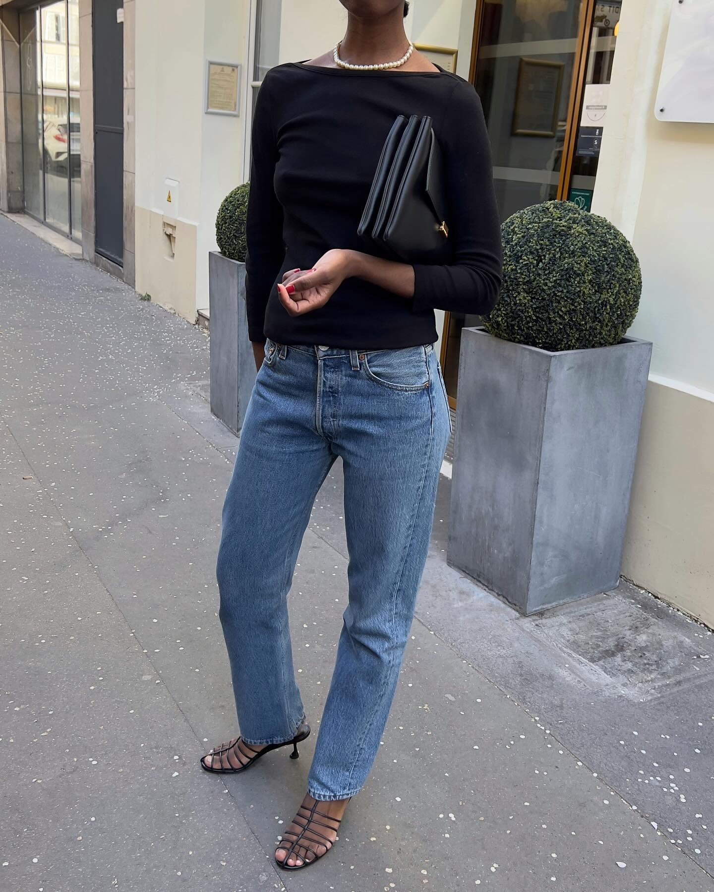 Influencer Sylvie wears a boatneck top with blue jeans.