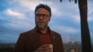 Seth Rogen's Matt holding a coffee cup as he stands in the back yard of an LA home in The Studio